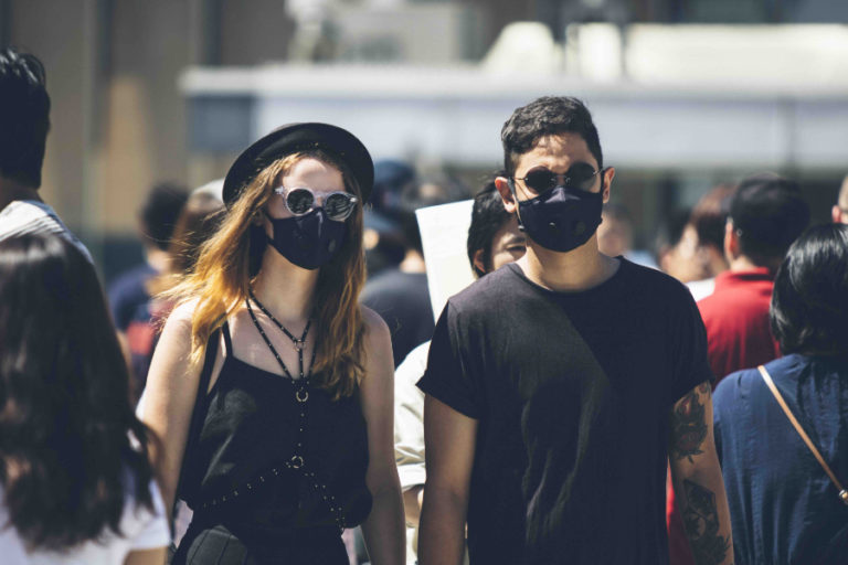 2 People Wearing Airinum Masks In Crowd Copy Global Wellness Summit 9394